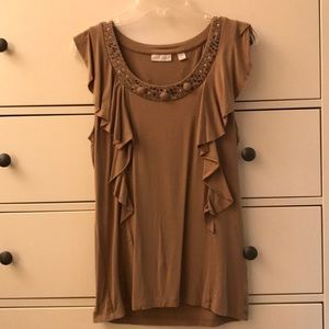 Beige top with sequence accents around collar